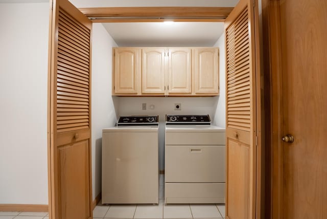 laundry room featuring light tile patterned flooring, cabinet space, and independent washer and dryer