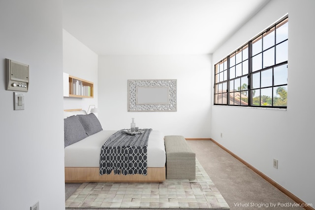 bedroom featuring baseboards and carpet floors