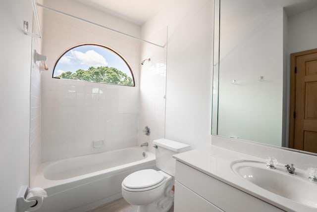 bathroom featuring vanity, toilet, and washtub / shower combination