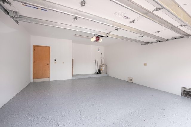 garage with electric water heater and a garage door opener