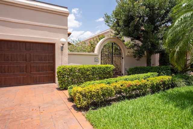 view of exterior entry featuring stucco siding and a garage