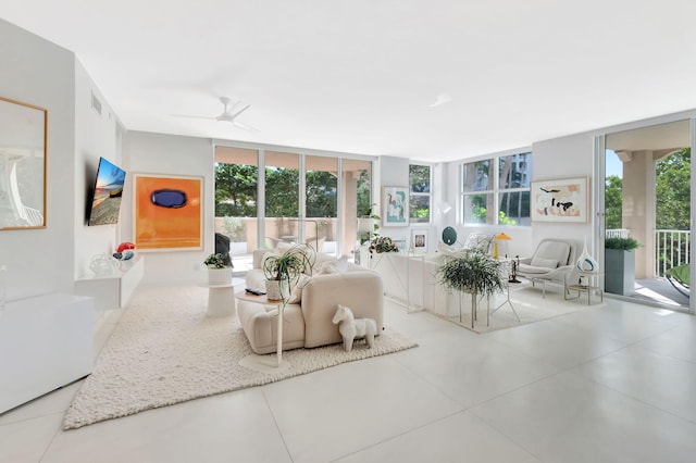 living room with a wall of windows, visible vents, and ceiling fan