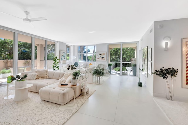 tiled living room with expansive windows, plenty of natural light, and visible vents