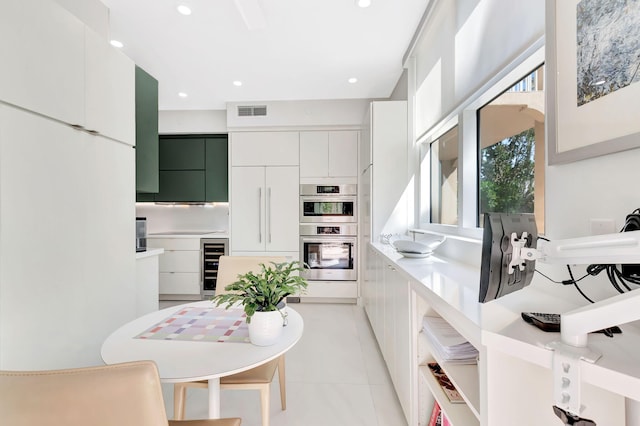 kitchen with visible vents, beverage cooler, double oven, recessed lighting, and modern cabinets