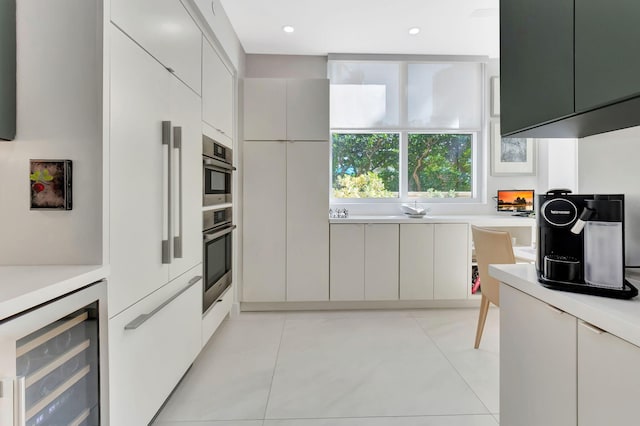 kitchen featuring modern cabinets, beverage cooler, and light countertops