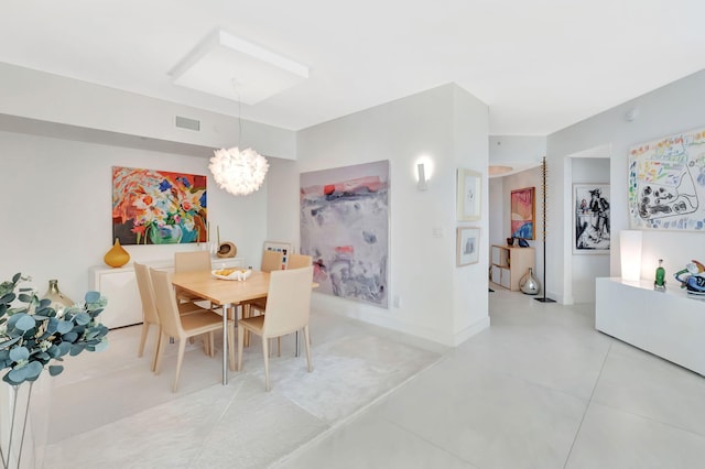 dining area with a notable chandelier, baseboards, and visible vents