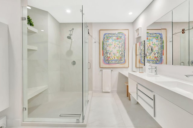 full bathroom featuring a sink, a stall shower, and double vanity