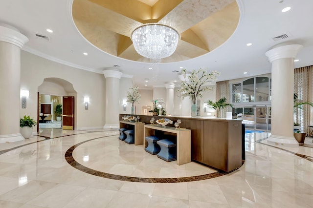 reception with visible vents, an inviting chandelier, and ornate columns