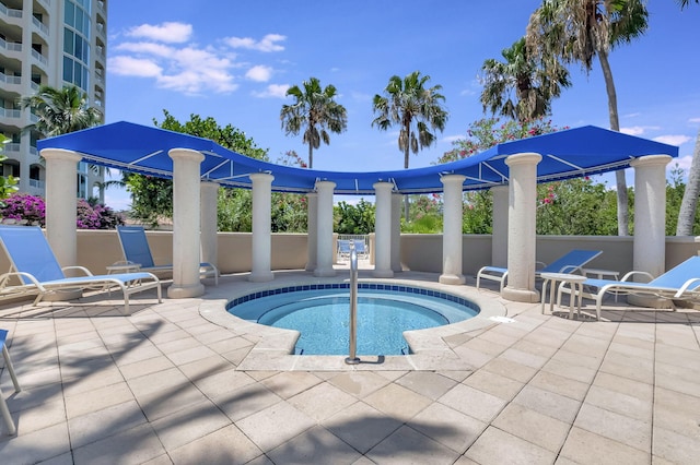 view of pool featuring a hot tub and a patio area