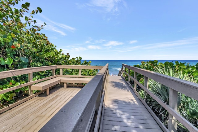 surrounding community with a water view and a view of the beach