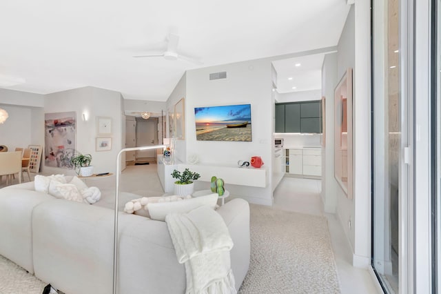 carpeted living room featuring recessed lighting, visible vents, and a ceiling fan