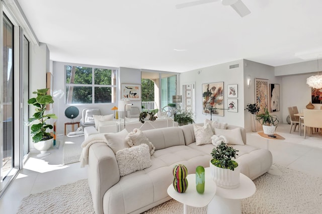 living room with visible vents, a chandelier, and floor to ceiling windows