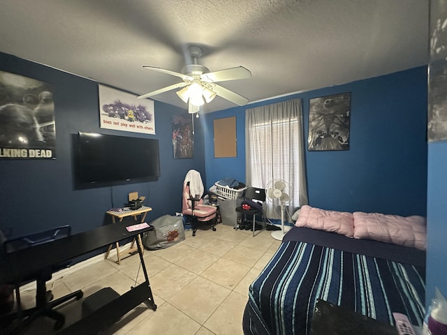 bedroom featuring tile patterned floors, a textured ceiling, and ceiling fan