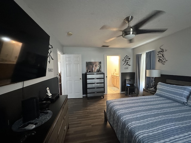 bedroom with visible vents, connected bathroom, dark wood-style floors, a textured ceiling, and a ceiling fan