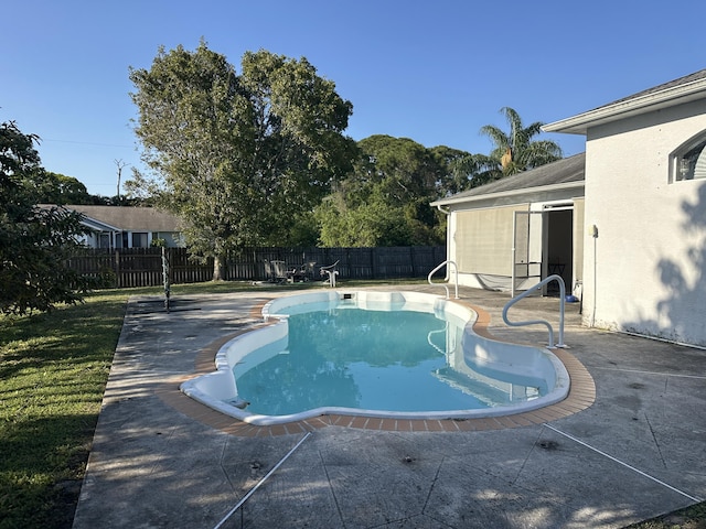 view of pool featuring a patio area, a fenced in pool, and a fenced backyard