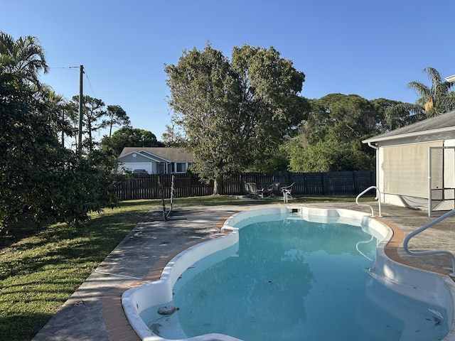 view of swimming pool with a patio, a yard, a fenced backyard, and a fenced in pool