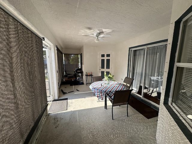 sunroom / solarium featuring ceiling fan