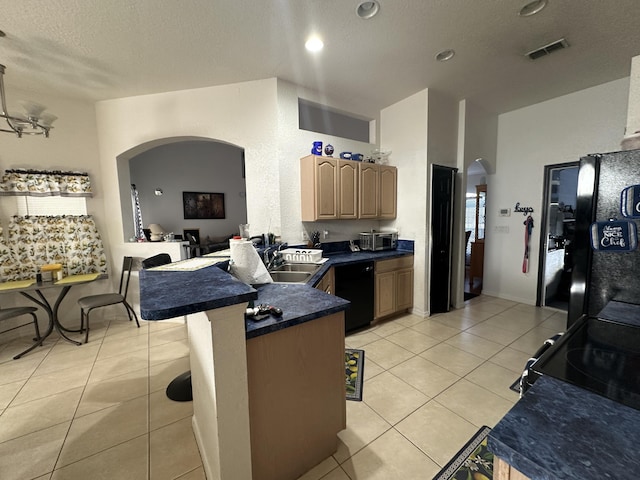 kitchen with visible vents, black appliances, a sink, dark countertops, and arched walkways