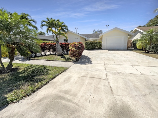 view of front of home featuring a garage, driveway, and stucco siding