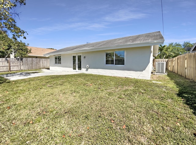 rear view of house with french doors, a patio, a fenced backyard, and stucco siding