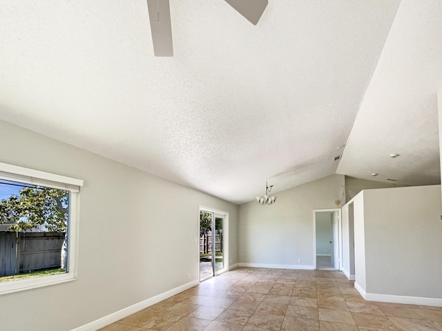 unfurnished room featuring baseboards, a textured ceiling, a chandelier, and vaulted ceiling