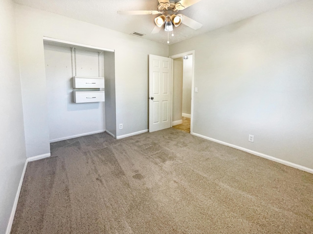 unfurnished bedroom with a closet, baseboards, visible vents, and carpet floors