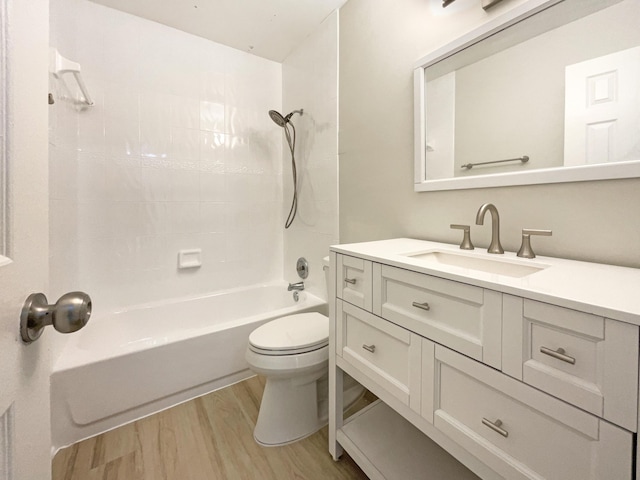 bathroom featuring vanity, toilet, wood finished floors, and shower / bath combination