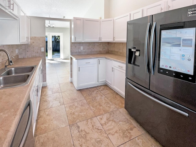 kitchen with a sink, light countertops, white cabinetry, and stainless steel appliances