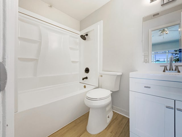 full bathroom with vanity, wood finished floors, visible vents, shower / bath combination, and toilet