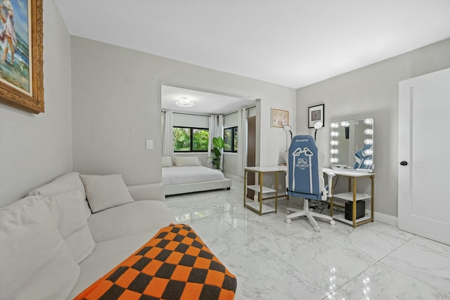 living area featuring baseboards and marble finish floor