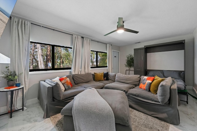 living room with visible vents, marble finish floor, a ceiling fan, and baseboards