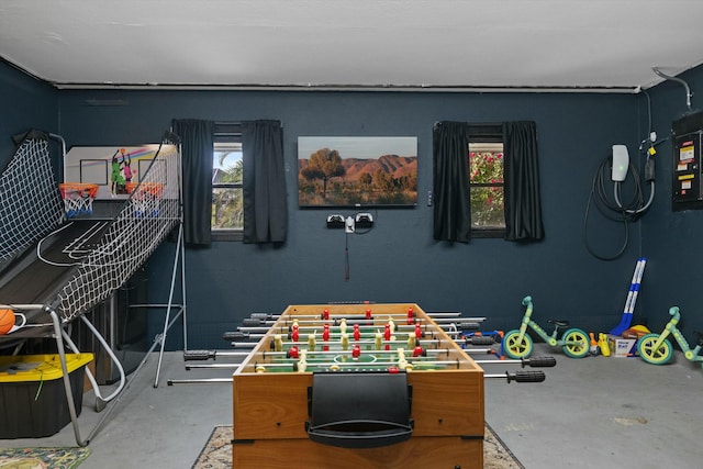 recreation room with concrete flooring