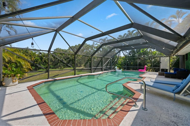 outdoor pool with glass enclosure and a patio area