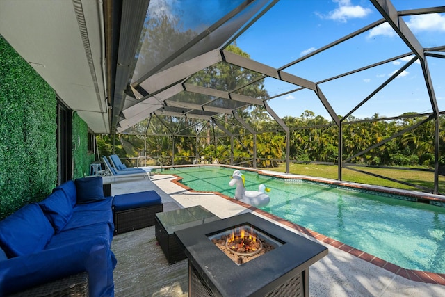 outdoor pool with a lanai, a lawn, an outdoor living space with a fire pit, and a patio