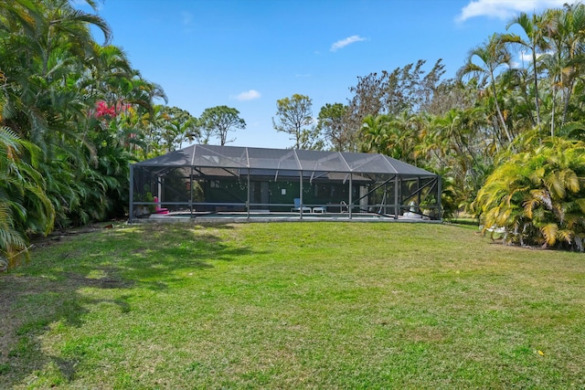 view of yard with a lanai and an outdoor pool