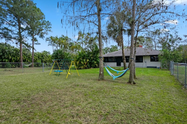 view of yard with a fenced backyard and a playground