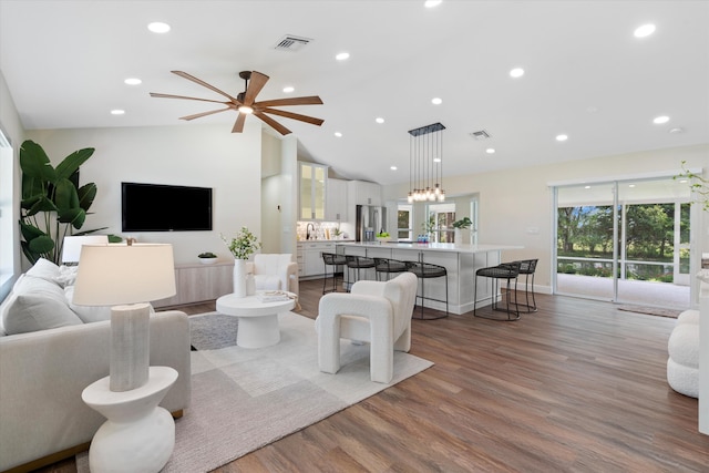 17393 84th Ct N, Loxahatchee, FL 33470 - living area with wood finished floors, vaulted ceiling, ceiling fan, and recessed lighting