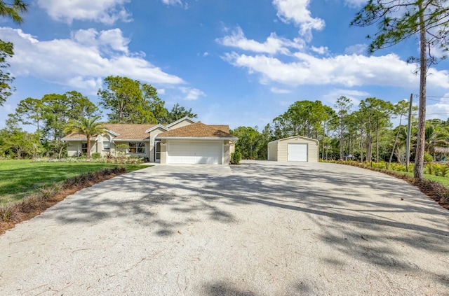 view of front facade with a garage, driveway, and stucco siding