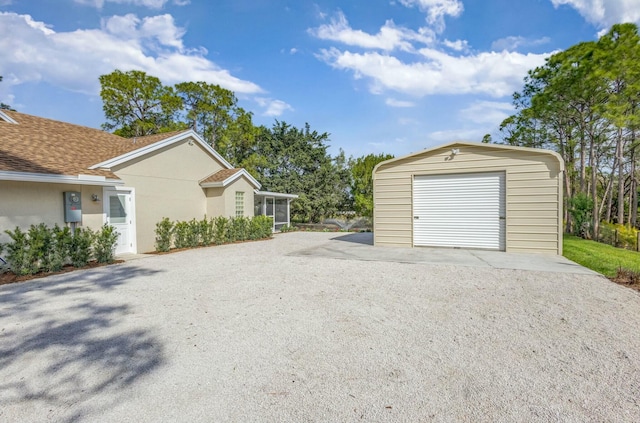 garage with gravel driveway