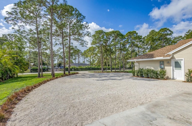 view of community with gravel driveway