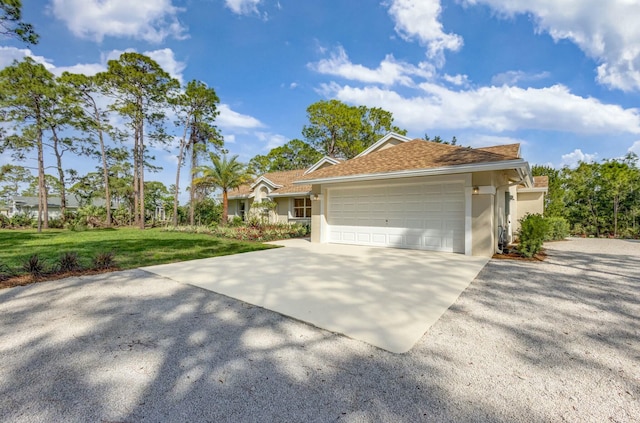 view of front facade featuring concrete driveway, an attached garage, a front yard, and stucco siding