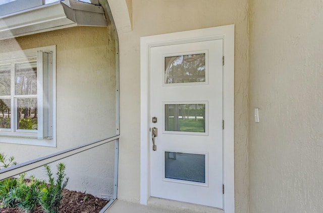 property entrance featuring stucco siding