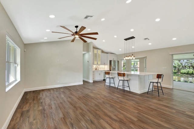 kitchen featuring white cabinets, plenty of natural light, visible vents, and stainless steel refrigerator with ice dispenser