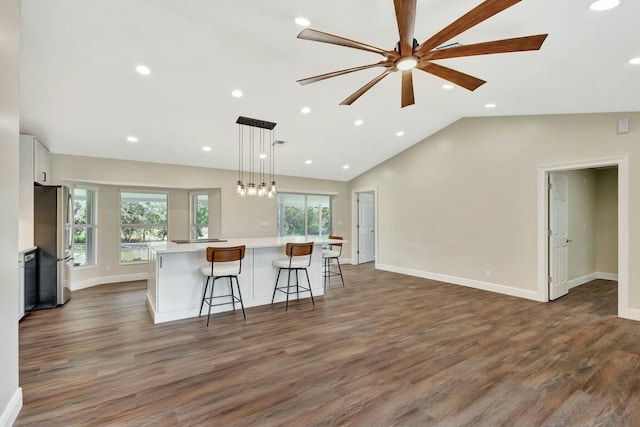 kitchen featuring white cabinetry, light countertops, a healthy amount of sunlight, and freestanding refrigerator