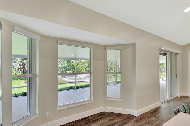 empty room with dark wood-style floors and baseboards