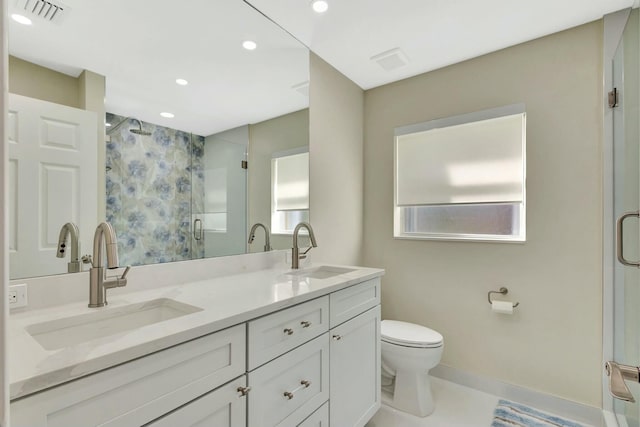 full bath with a sink, visible vents, toilet, and a shower stall