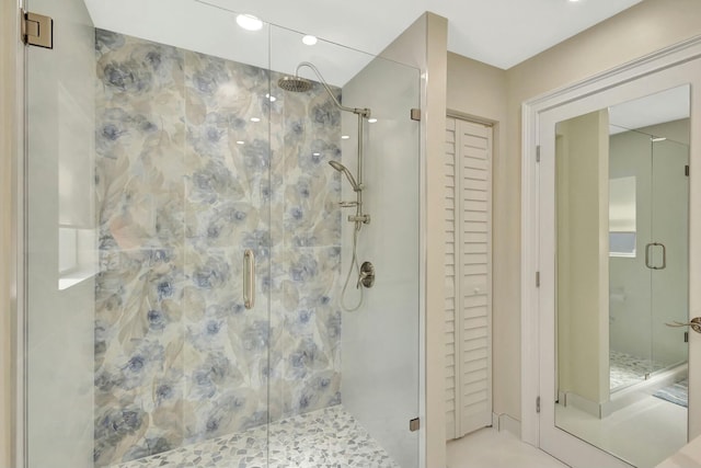 full bathroom featuring a closet and a shower stall