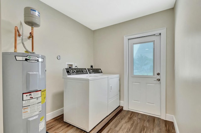 17393 84th Ct N, Loxahatchee, FL 33470 - laundry room with water heater, washing machine and clothes dryer, light wood-style floors, and baseboards