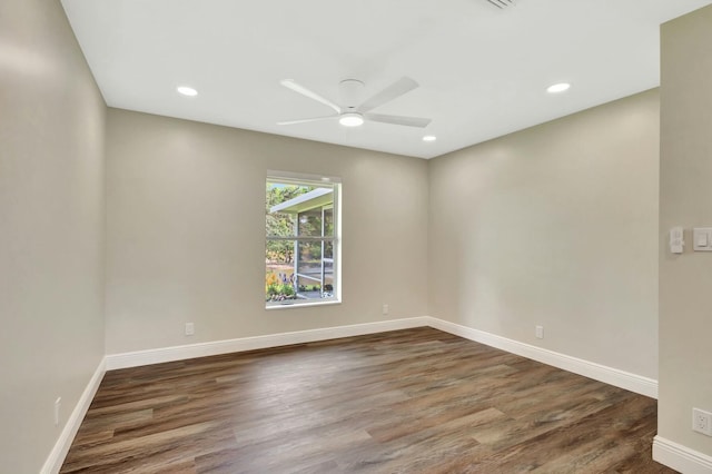 spare room with a ceiling fan, recessed lighting, wood finished floors, and baseboards