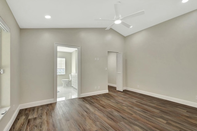 unfurnished bedroom featuring dark wood-type flooring, recessed lighting, connected bathroom, baseboards, and vaulted ceiling